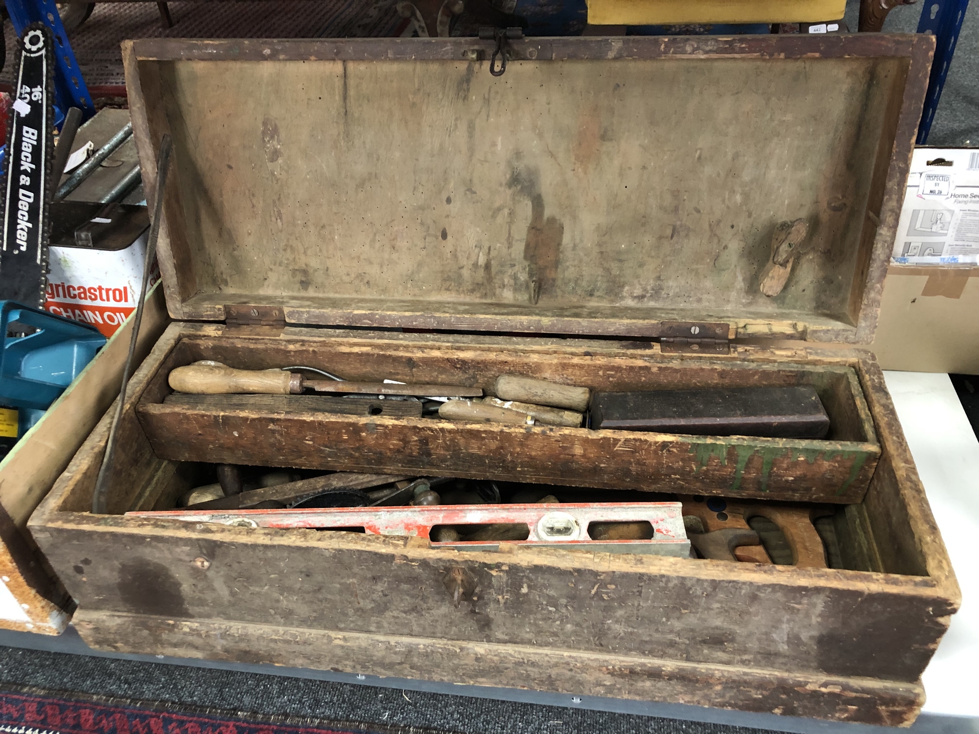 A vintage pine joiner's tool box containing hand tools,