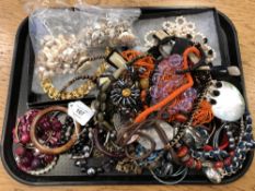 A tray of costume jewellery, bangles, simulated pearls,