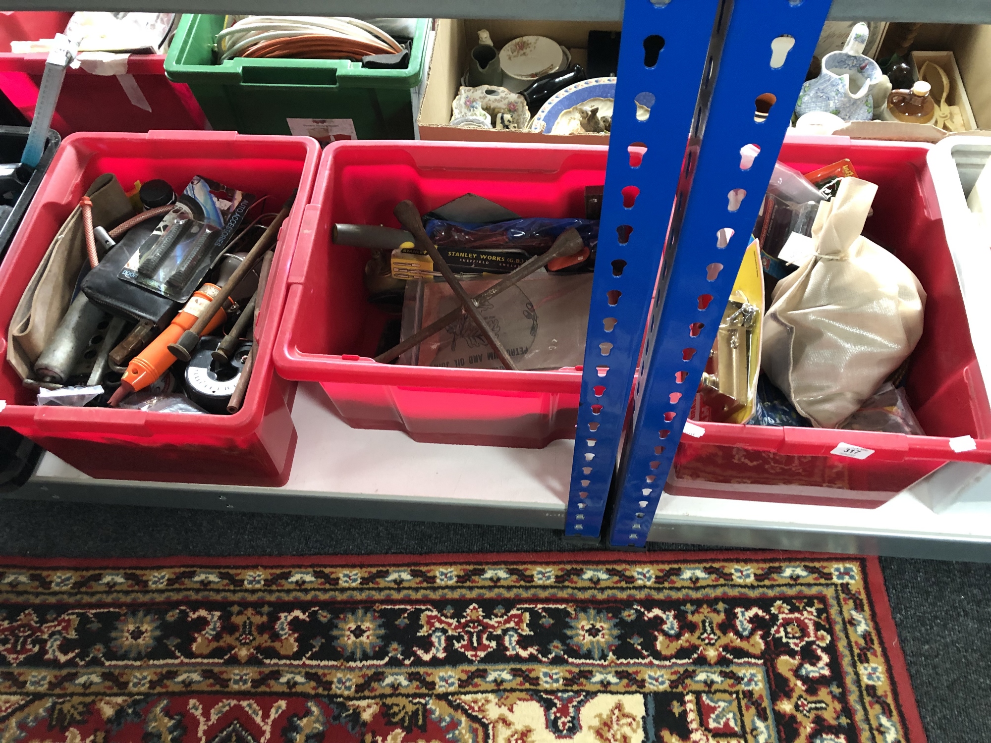 Three crates containing a quantity of assorted hand tools, door locks, inspection lamp,