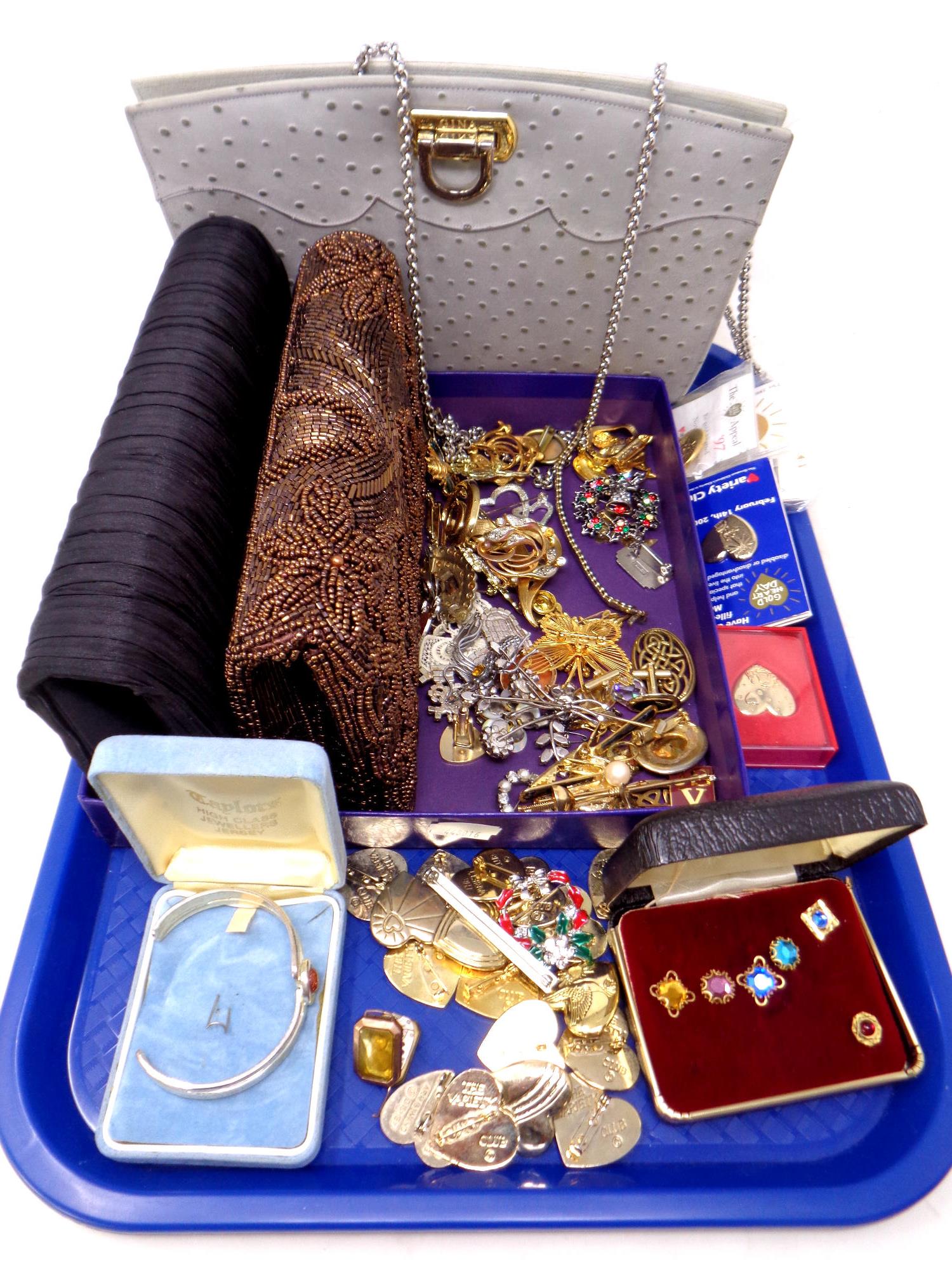 A tray of lady's hand bags, costume jewellery, 9ct gold watch case.