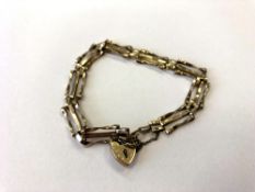 A 9ct gold padlock bracelet CONDITION REPORT: 4.