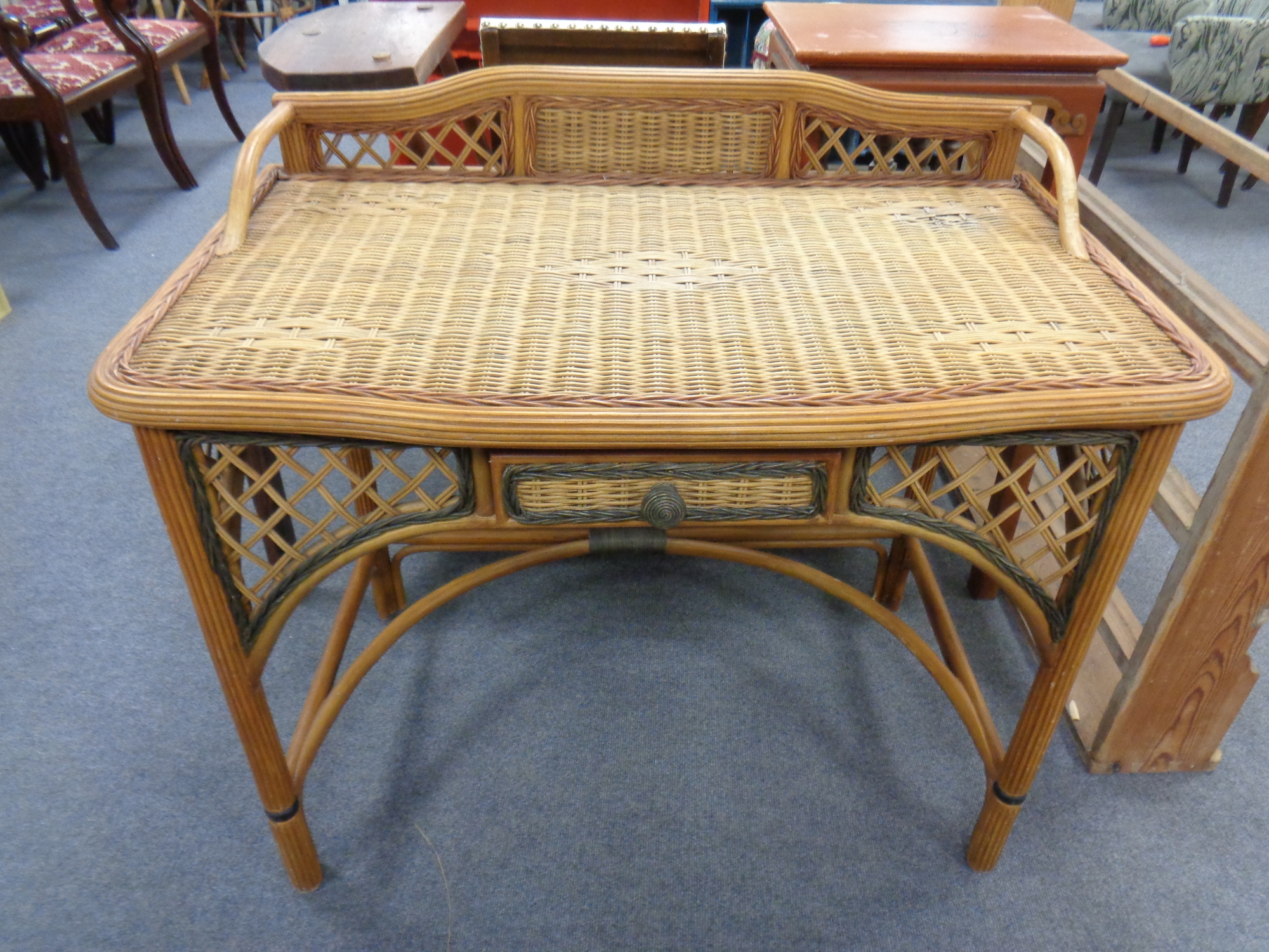 A bamboo and wicker dressing table fitted with a drawer