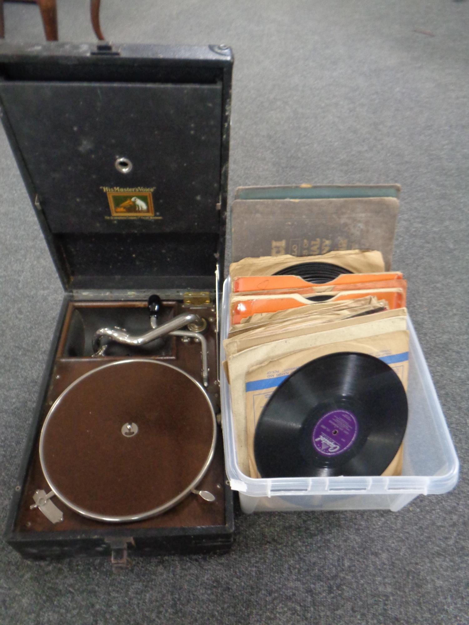 A 1930's HMV portable gramophone together with a box containing 78's