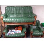 An oak framed green leather three piece lounge suite comprising of three seater settee two seater