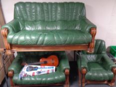 An oak framed green leather three piece lounge suite comprising of three seater settee two seater