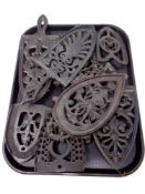 A tray of Continental cast iron trivets