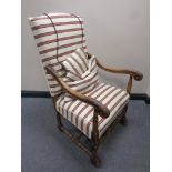 A 20th century carved beech framed armchair in striped fabric