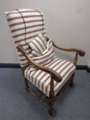 A 20th century carved beech framed armchair in striped fabric