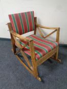 A Scandinavian mid century rocking chair in striped fabric