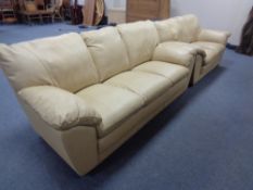 A cream leather three seater settee with matching two seater settee