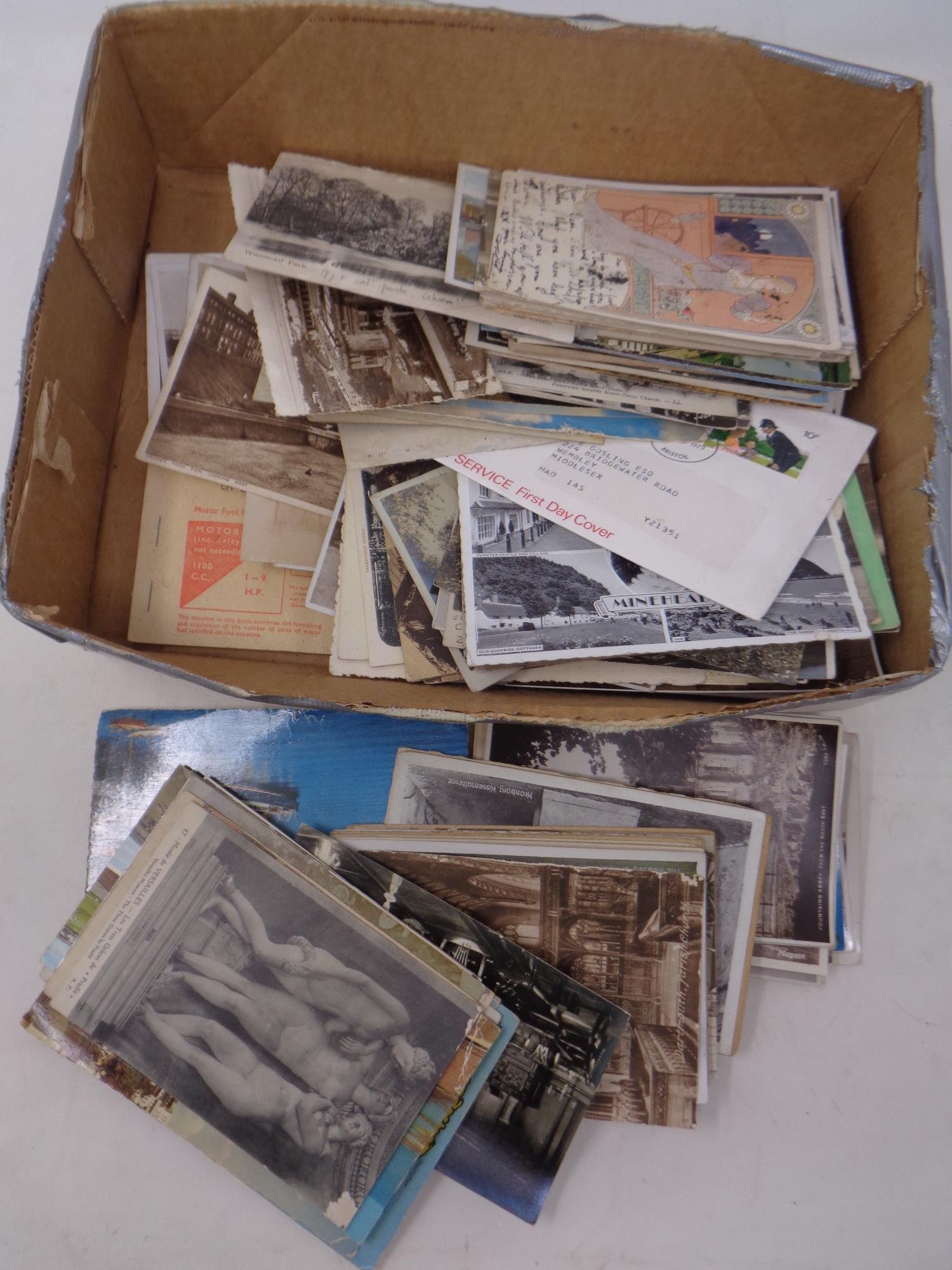 A box of antique and later postcards