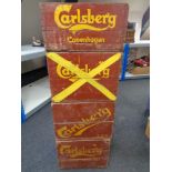 Four vintage brewery crates bearing Carlsberg advertising