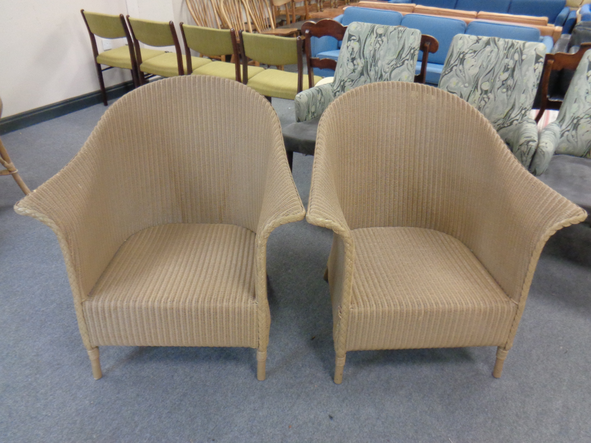 A pair of over sized painted loom armchairs