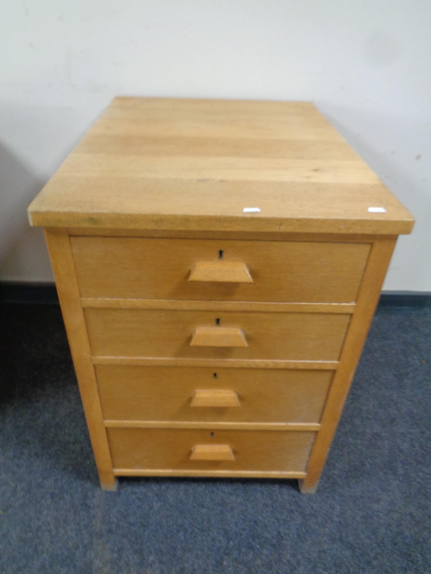 A 20th century oak four drawer office chest