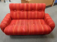 A mid century Danish two seater settee in red striped fabric