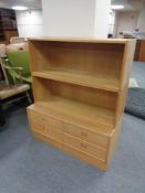 Two Danish four drawer chests fitted with shelves above in oak finish