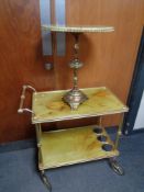 A gilt wood and faux marble two tier tea trolley together with similar wine table