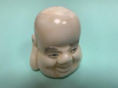 A Japanese carved bone netsuke - Head of Buddha.