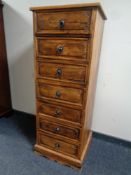 A contemporary narrow seven drawer chest