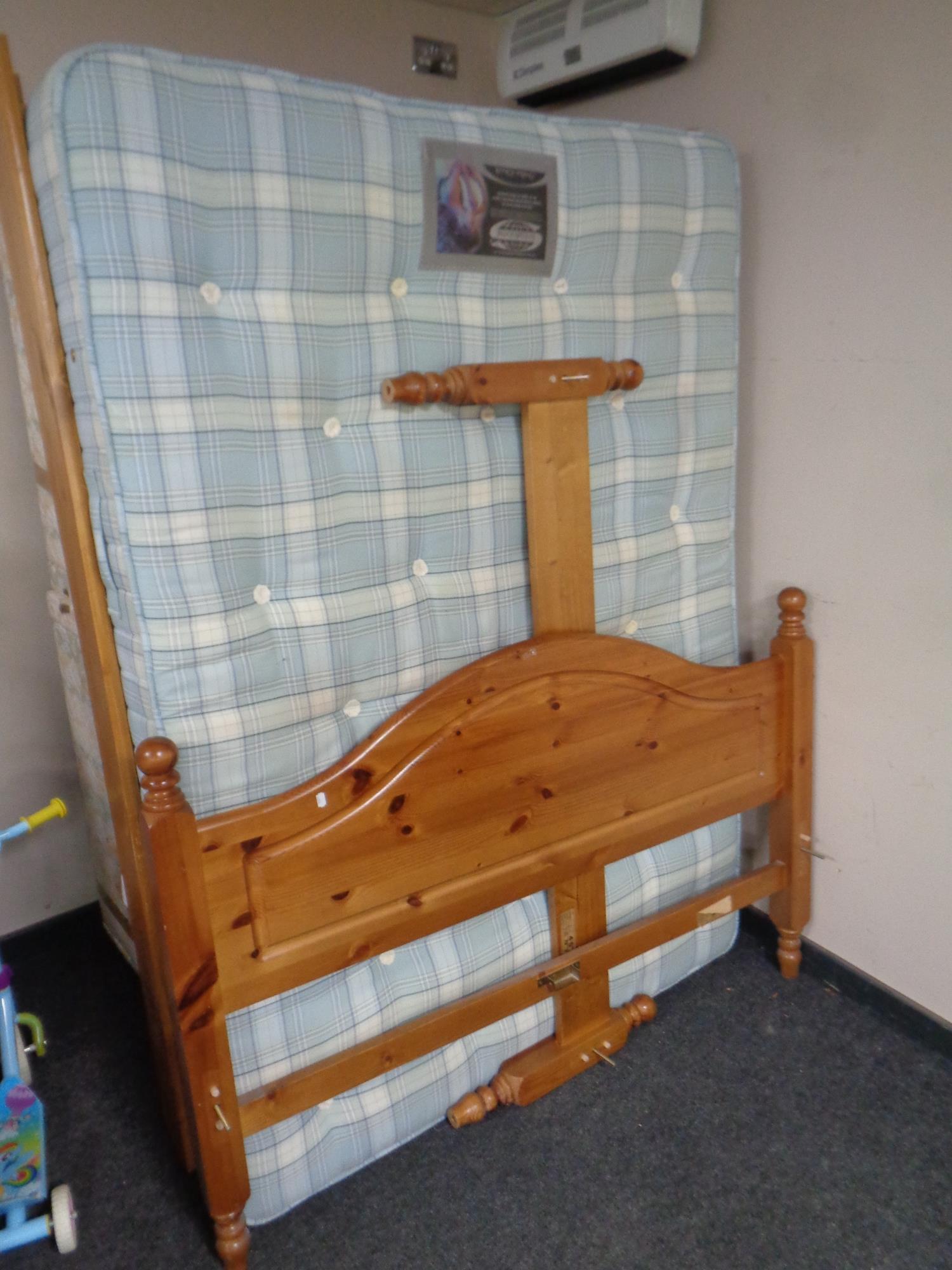 A 4' 6 pine bed frame with Simmons Ortho check interior