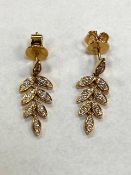 A pair of 18ct yellow gold diamond leaf earrings