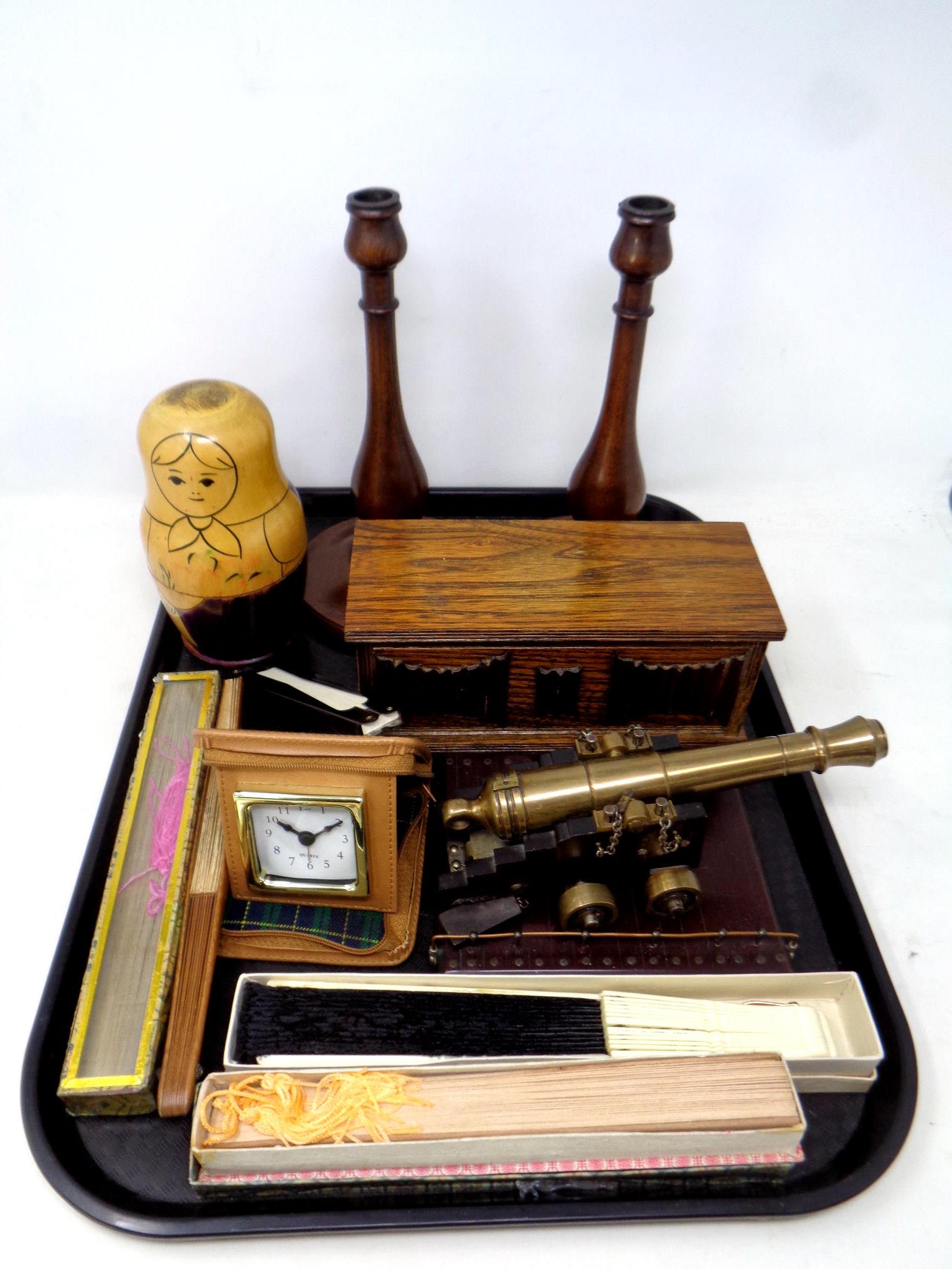 A tray containing oak musical jewellery box, Edwardian candlesticks, Russian dolls, hand fans,