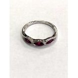 An 18ct white gold ruby and diamond band ring