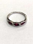 An 18ct white gold ruby and diamond band ring