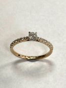 A 9ct solitaire diamond ring, set with diamond shoulders, approximately 0.3ct.