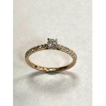 A 9ct solitaire diamond ring, set with diamond shoulders, approximately 0.3ct.