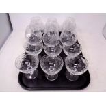A tray containing six etched glass oversized brandy glasses together with a set of Martini glasses