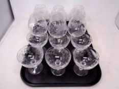 A tray containing six etched glass oversized brandy glasses together with a set of Martini glasses