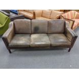 A Danish 20th century three seater settee in brown leather