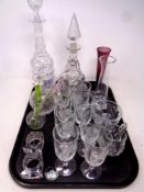 A tray of glass, decanters with ceramics labels, etched drinking glasses, vases,