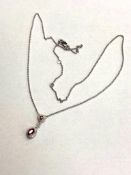 A 9ct white gold ruby and diamond pendant, the ruby approximately 0.45ct.