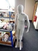 A female fabric mannequin on stand