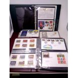 An album containing Coin & Stamps first day covers,