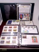 An album containing Coin & Stamps first day covers,