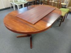 A mid century Danish circular rosewood dining table with two leaves