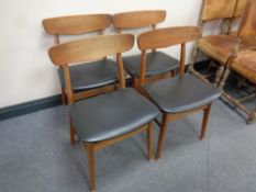 A set of four mid century teak dining chairs
