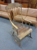 An antique pine beech spindle backed rocking chair