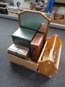 A pine magazine rack together with a box containing small vintage leather suitcase,