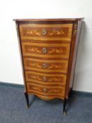 A French inlaid mahogany serpentine fronted five drawer chest on raised legs with brass mounts