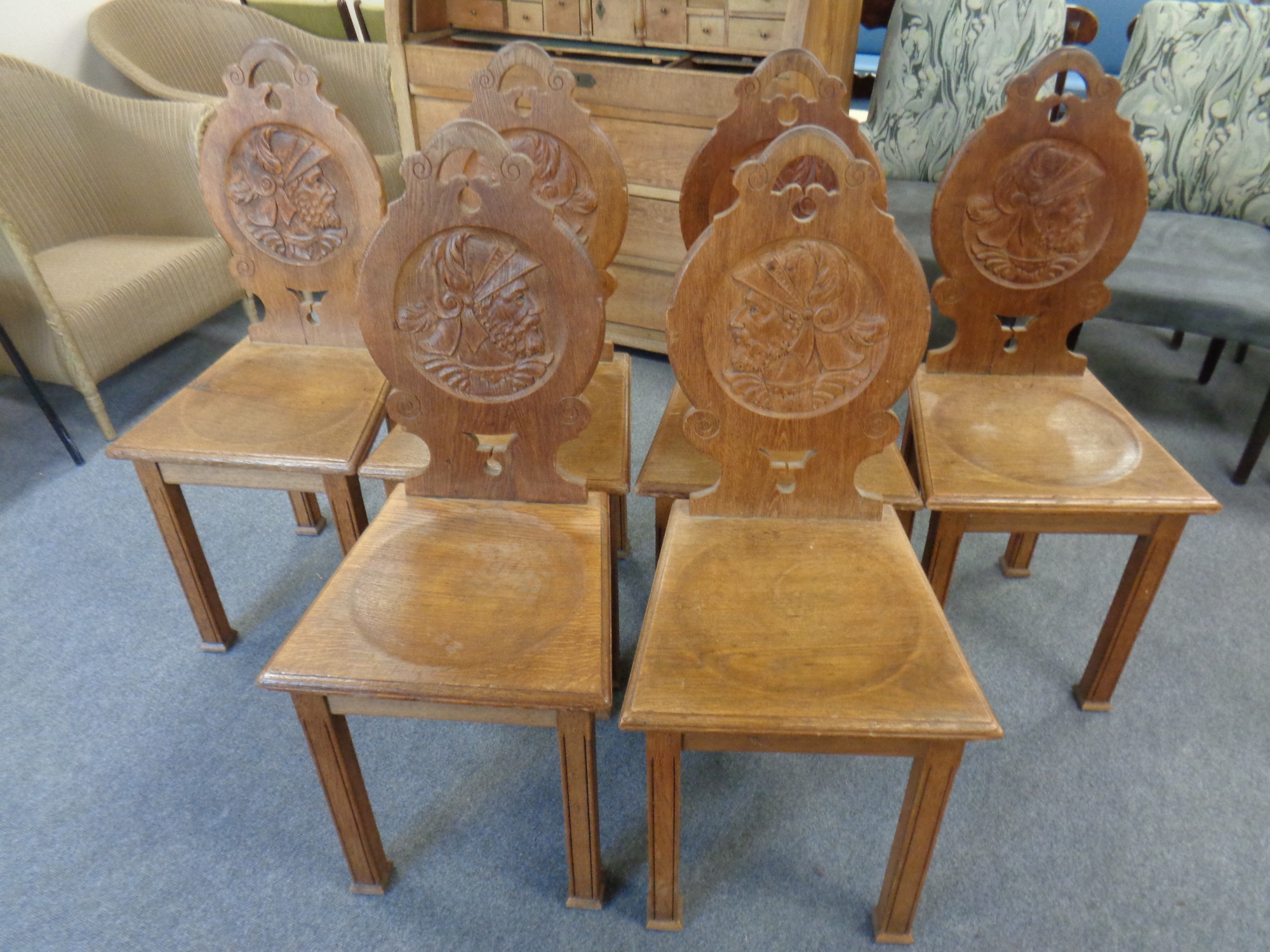 A set of six 20th century carved oak dining chairs
