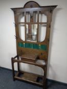 A 19th century oak mirrored and tiled hall stand
