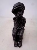 A contemporary 'Lee Anne' figure modelled as a boy seated, height 20 cm.