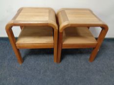 A pair of beechwood two tier occasional tables with undershelf and drawer