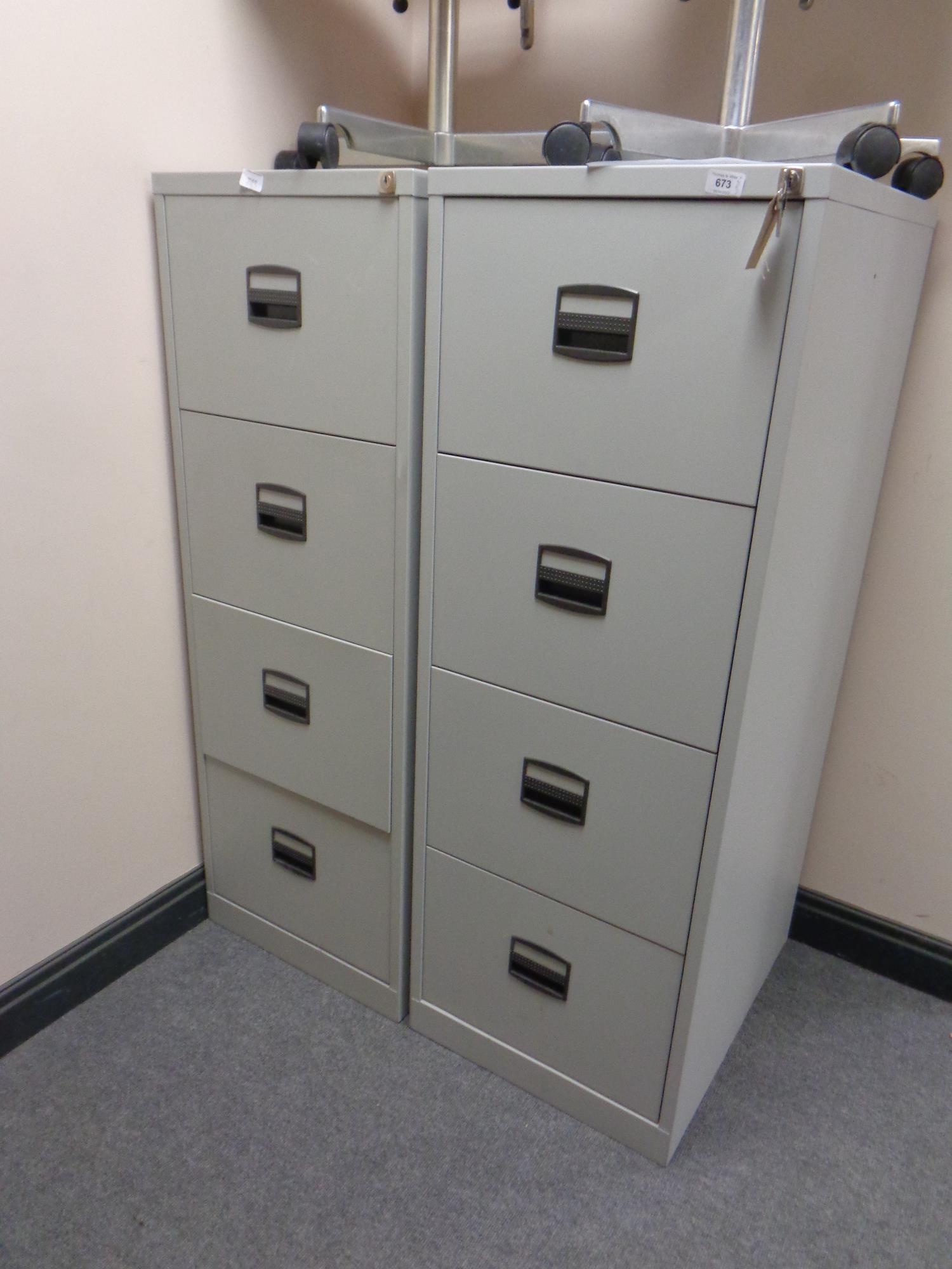 Two four drawer metal filing cabinets with keys