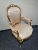 A gilt wood salon armchair in pink striped fabric