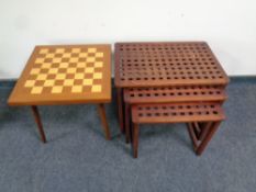 A chess board topped occasional table together with a nest of three lattice topped tables in